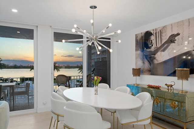 dining area featuring light hardwood / wood-style floors and a chandelier