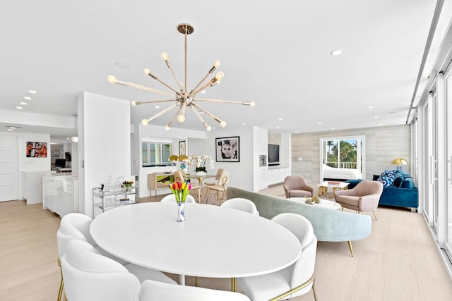 dining area featuring light hardwood / wood-style flooring and a chandelier