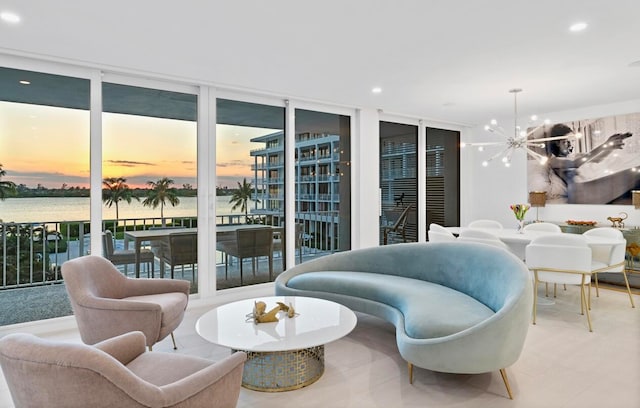 interior space featuring floor to ceiling windows, an inviting chandelier, and a water view