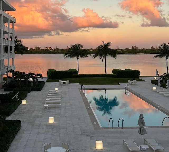 pool at dusk with a water view