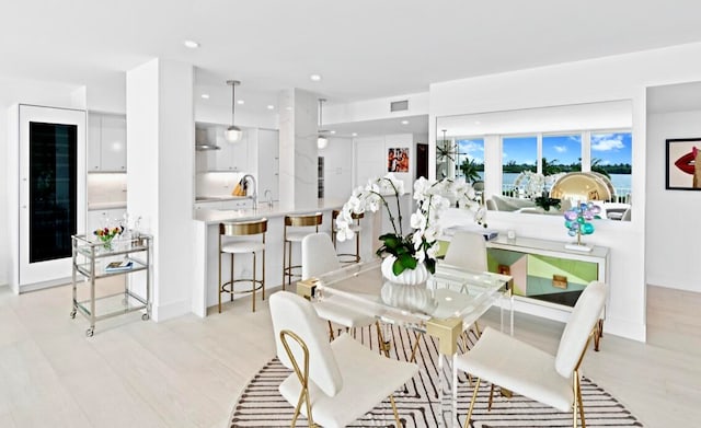 dining space with light wood-type flooring