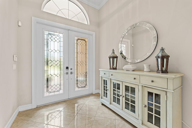 foyer entrance featuring french doors, plenty of natural light, and ornamental molding