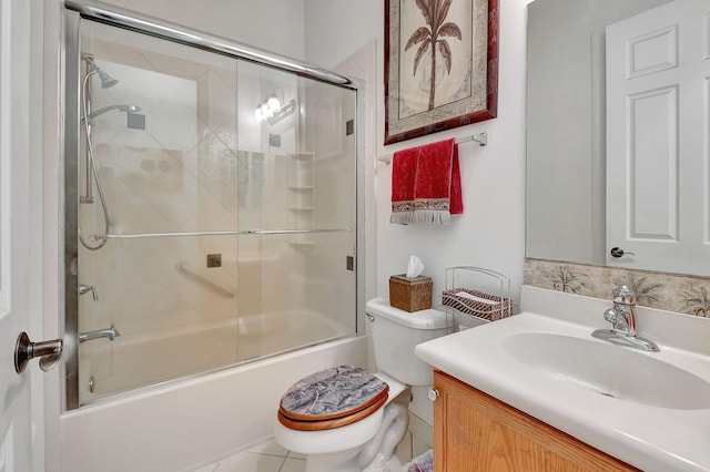 full bathroom with vanity, tile patterned floors, toilet, and combined bath / shower with glass door