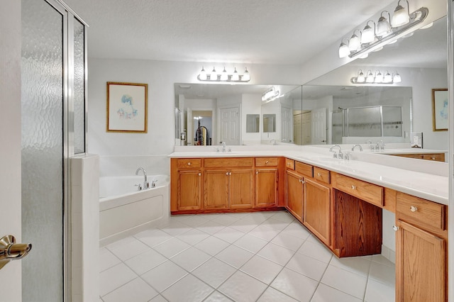 bathroom featuring independent shower and bath, vanity, a textured ceiling, and tile patterned floors