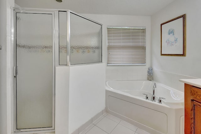 bathroom featuring vanity, plus walk in shower, and tile patterned floors