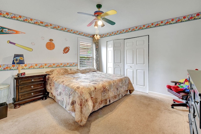 carpeted bedroom featuring ceiling fan and a closet