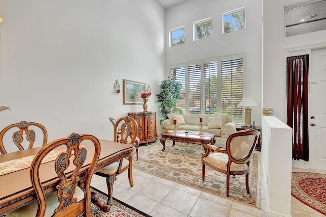 living room with a high ceiling and light tile patterned floors