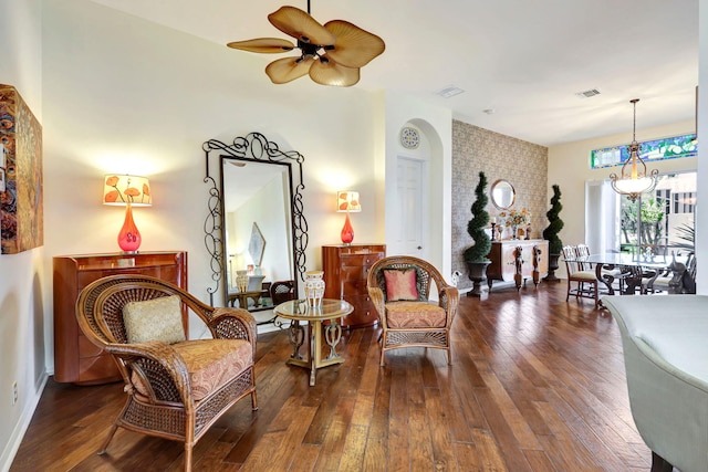 living area featuring ceiling fan and dark hardwood / wood-style flooring