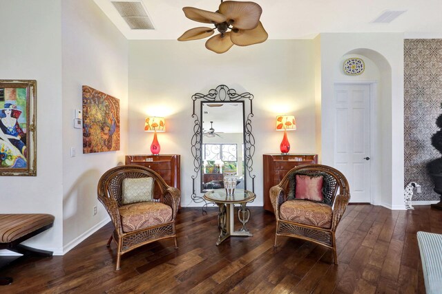 living area with ceiling fan and dark hardwood / wood-style floors