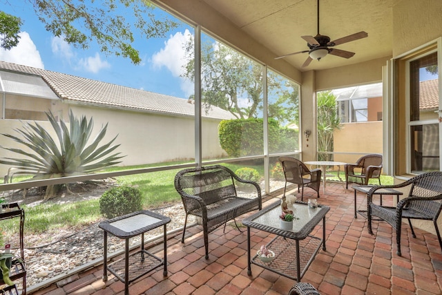 sunroom with ceiling fan and plenty of natural light