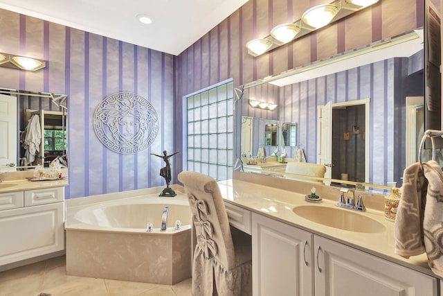 bathroom featuring tile patterned flooring, a washtub, and vanity