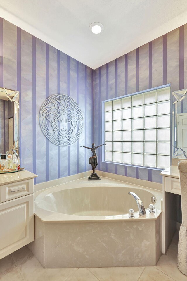 bathroom with tile patterned flooring, vanity, and a bathtub