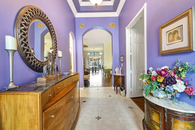 hall featuring crown molding, light hardwood / wood-style flooring, and a chandelier