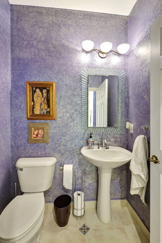 bathroom featuring toilet and tile patterned floors