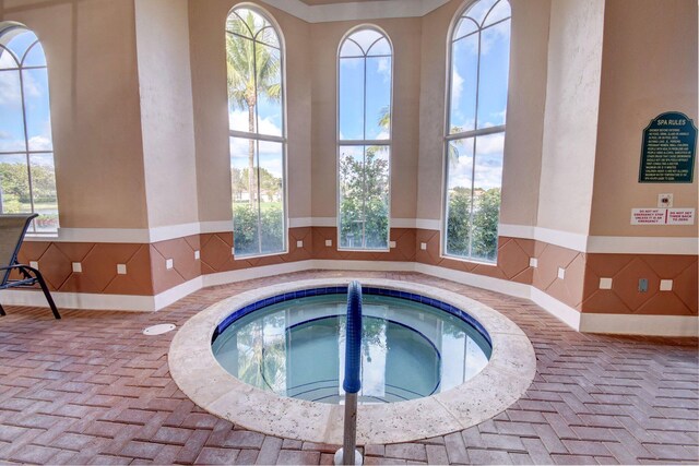 view of pool with an indoor hot tub