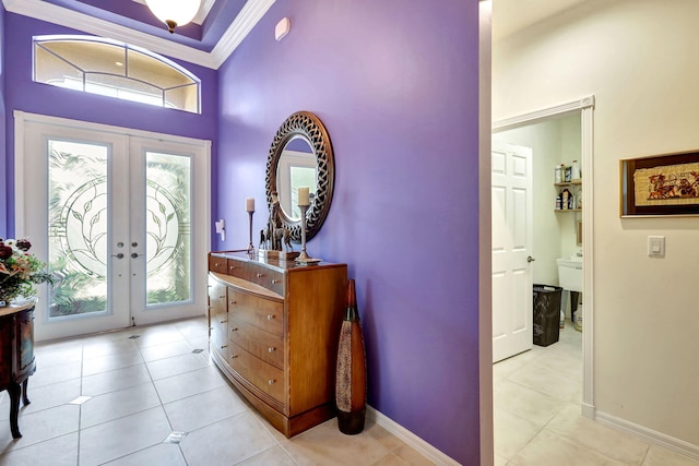 tiled entryway featuring ornamental molding, french doors, and a wealth of natural light