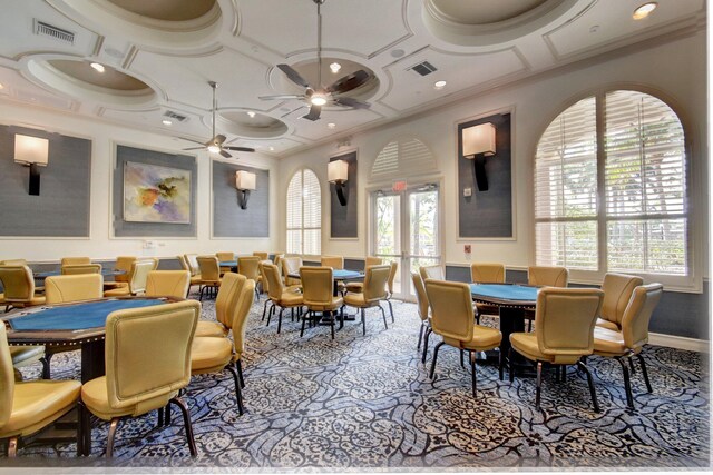 dining space featuring a wealth of natural light, crown molding, ceiling fan, and coffered ceiling