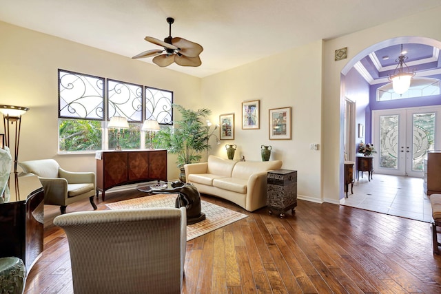 living room with ornamental molding, french doors, hardwood / wood-style floors, and ceiling fan