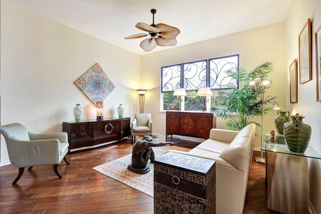 sitting room featuring dark wood-type flooring and ceiling fan