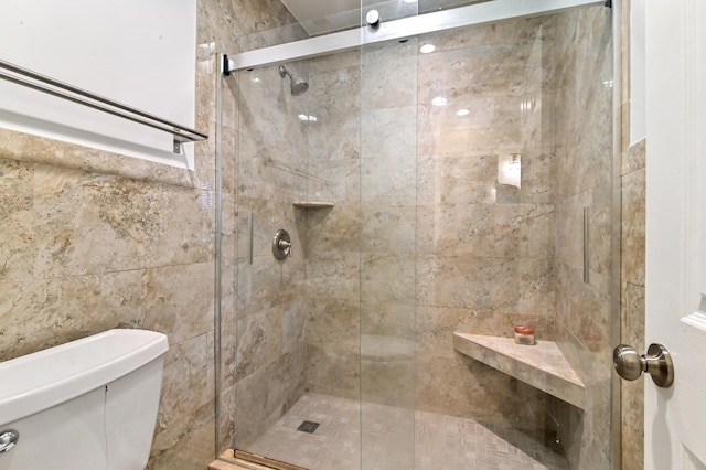 bathroom featuring toilet and an enclosed shower