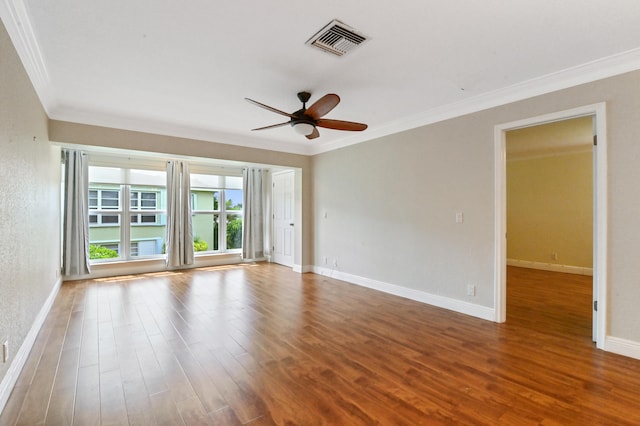 empty room with crown molding, wood-type flooring, and ceiling fan