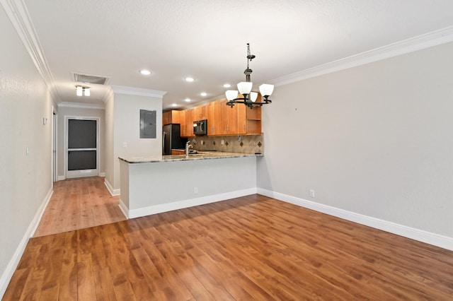 kitchen with light hardwood / wood-style flooring, kitchen peninsula, crown molding, electric panel, and stainless steel refrigerator