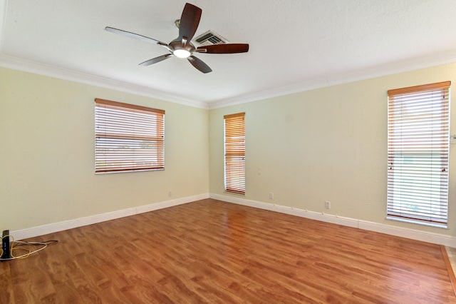 unfurnished room featuring ceiling fan, hardwood / wood-style flooring, and ornamental molding