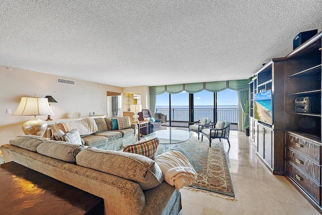 tiled living room with a textured ceiling