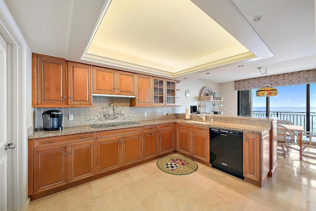 kitchen featuring dishwashing machine, a tray ceiling, a water view, and kitchen peninsula