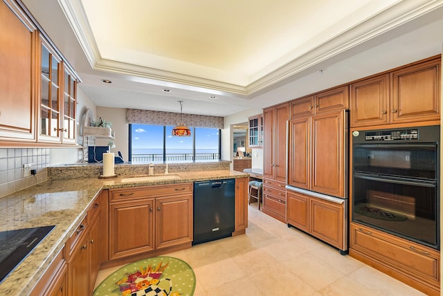 kitchen featuring ornamental molding, sink, black appliances, pendant lighting, and a tray ceiling