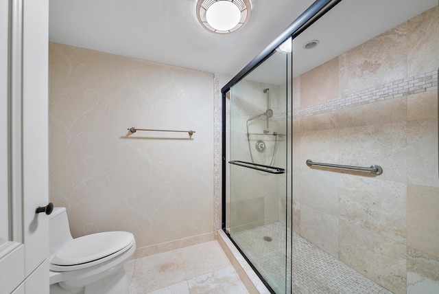 bathroom with an enclosed shower, toilet, and tile patterned floors