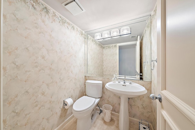 bathroom featuring sink, tile patterned flooring, and toilet