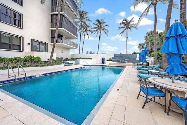 view of swimming pool featuring a patio area