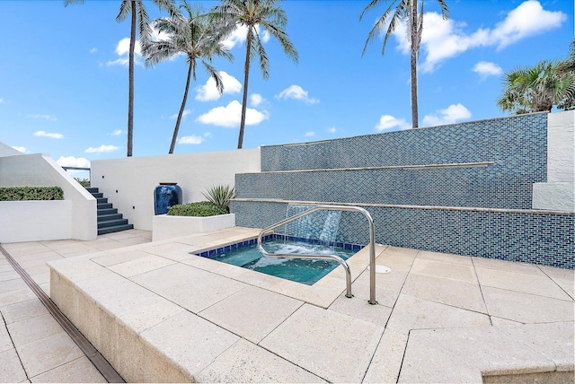 view of swimming pool with an in ground hot tub and a patio