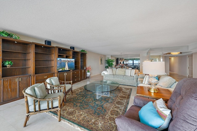 living room with light tile patterned flooring and a textured ceiling