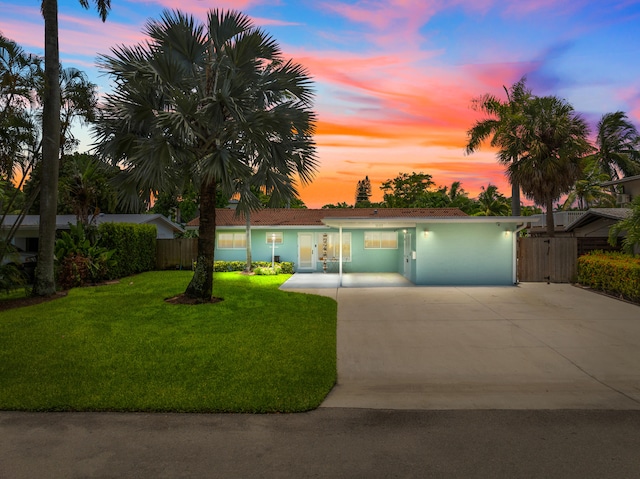 ranch-style home with a lawn