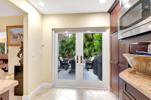 doorway to outside featuring light tile patterned flooring and french doors