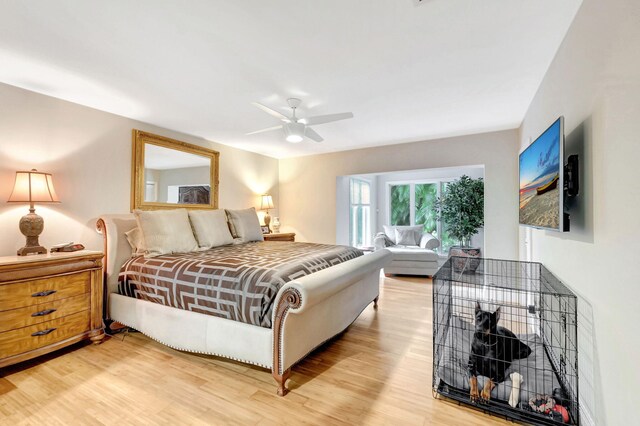 bedroom with ceiling fan and light hardwood / wood-style floors