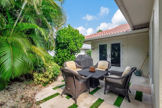 view of patio with french doors, area for grilling, and outdoor lounge area