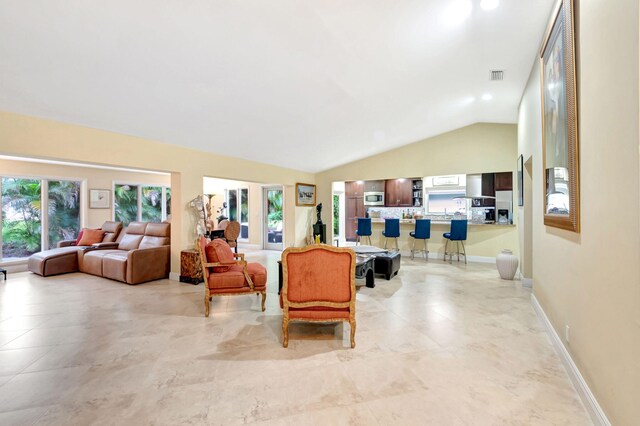 living room featuring lofted ceiling and light tile patterned flooring