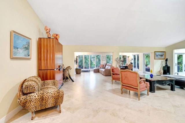 living room featuring vaulted ceiling and light tile patterned floors