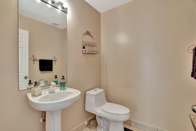 bathroom featuring tile patterned floors and toilet