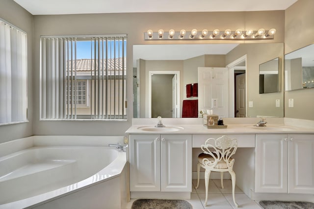 bathroom featuring tile patterned floors, vanity, and a bath