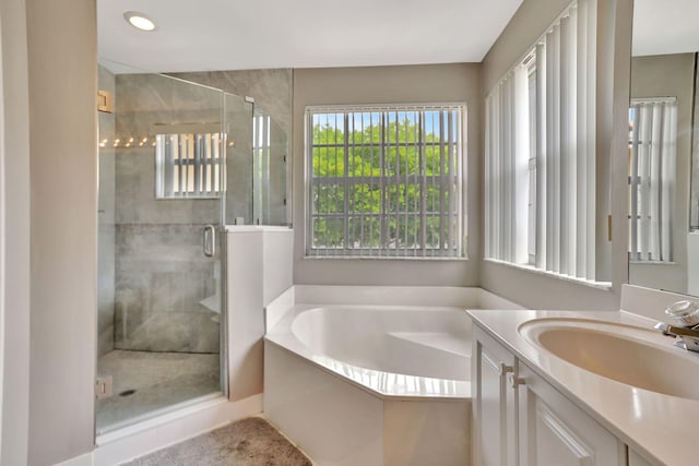 bathroom with separate shower and tub and vanity