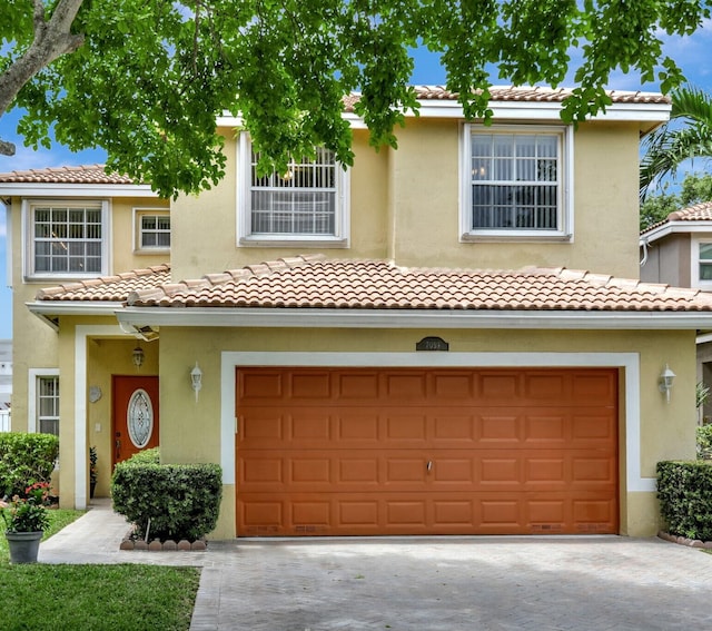 mediterranean / spanish home featuring a garage