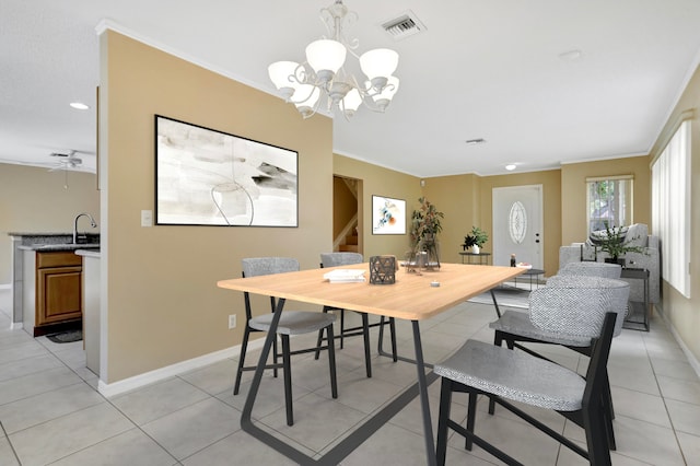 dining space with ceiling fan with notable chandelier, light tile patterned flooring, sink, and crown molding