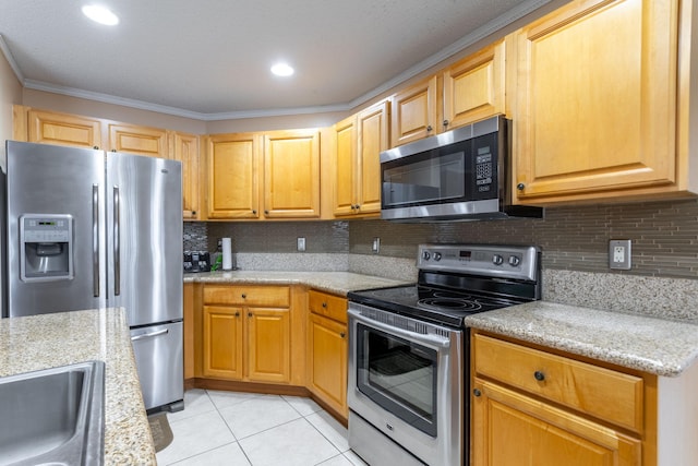 kitchen with backsplash, crown molding, light stone countertops, light tile patterned floors, and stainless steel appliances