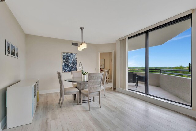 dining space with light wood-type flooring