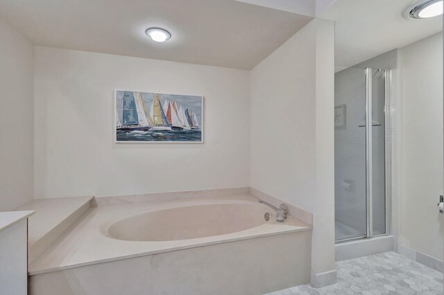 bathroom with tile patterned floors and separate shower and tub