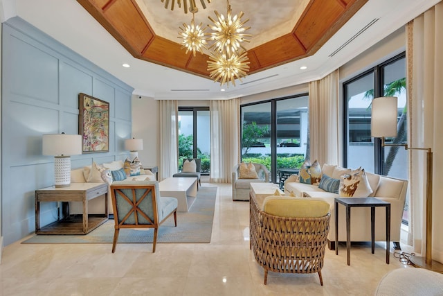 interior space with a raised ceiling, crown molding, and a chandelier